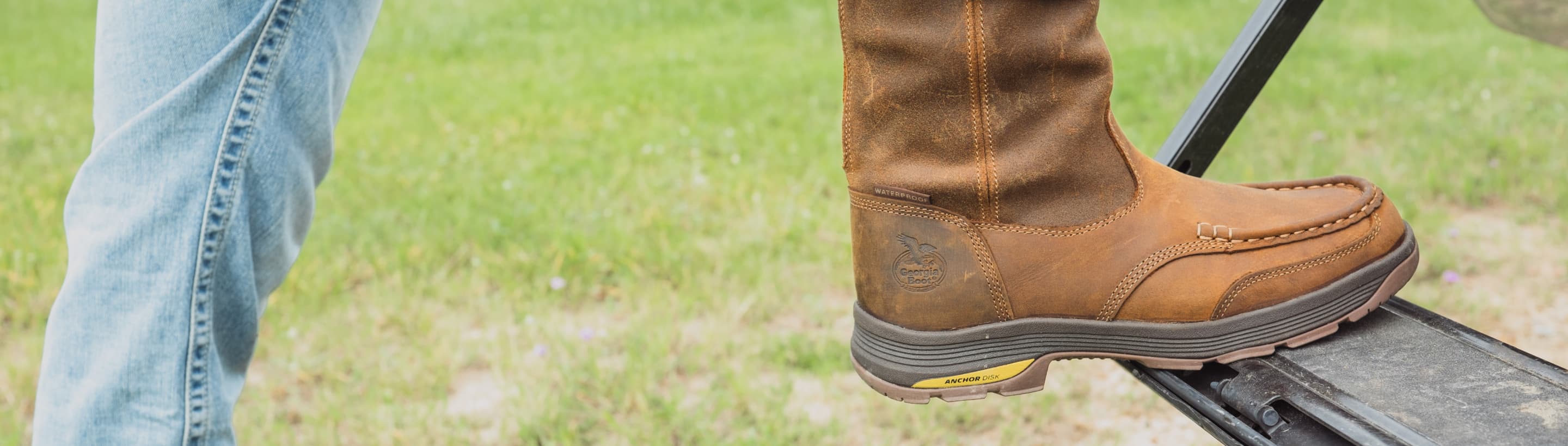 the foot of someone wearing a leather Georgia Boot, steppin up onto something